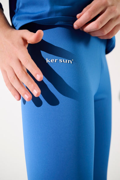 Legging de bain anti-UV - Fidji en bleu, porté par un enfant, offrant protection solaire UPF 50+ et confort.