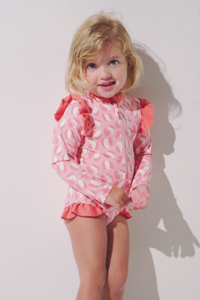 Maillot de bain anti-UV manches longues - Flores pour enfant, rose à motifs, UPF 50+, idéal pour jouer au soleil.